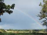 Rainbow rising over the fields around Barrusclet